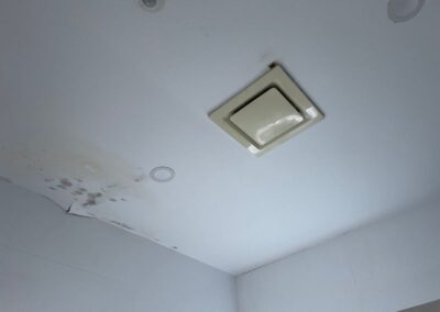 before picture of water damaged ceiling in bathroom near extraction fan
